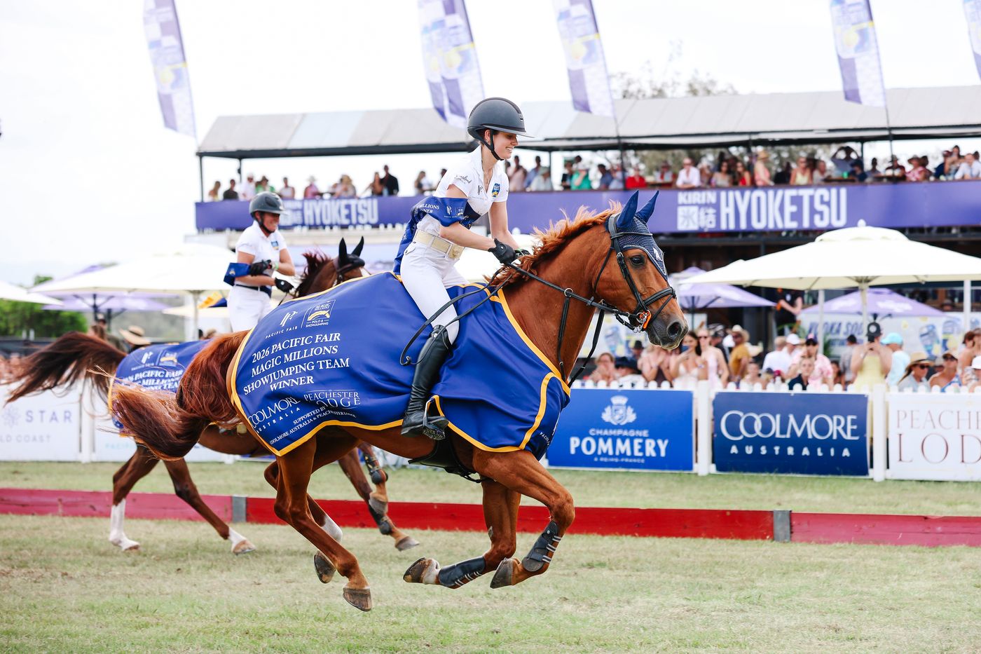 Showjumping team winner's lap in front of the grandstand